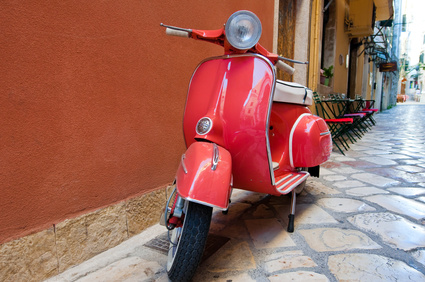 Classic Vespa scooter on Kerkyra street. Corfu island. Greece.